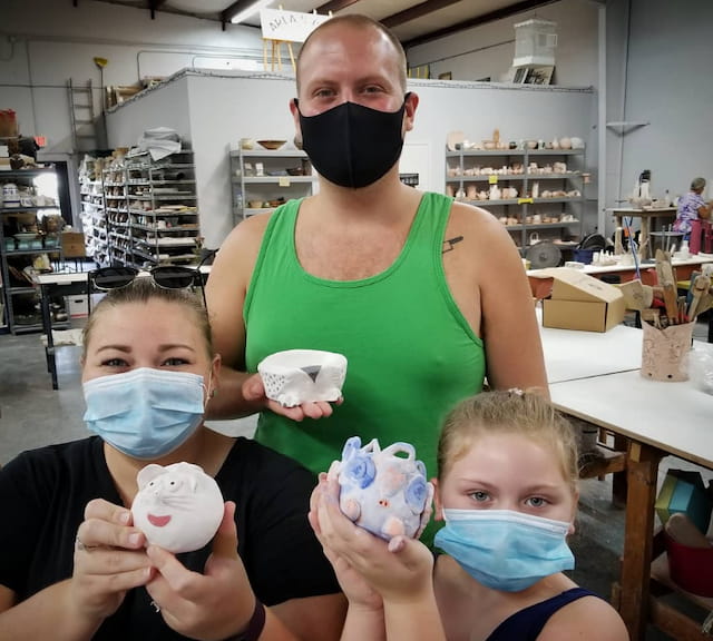 a woman with a group of kids wearing face masks