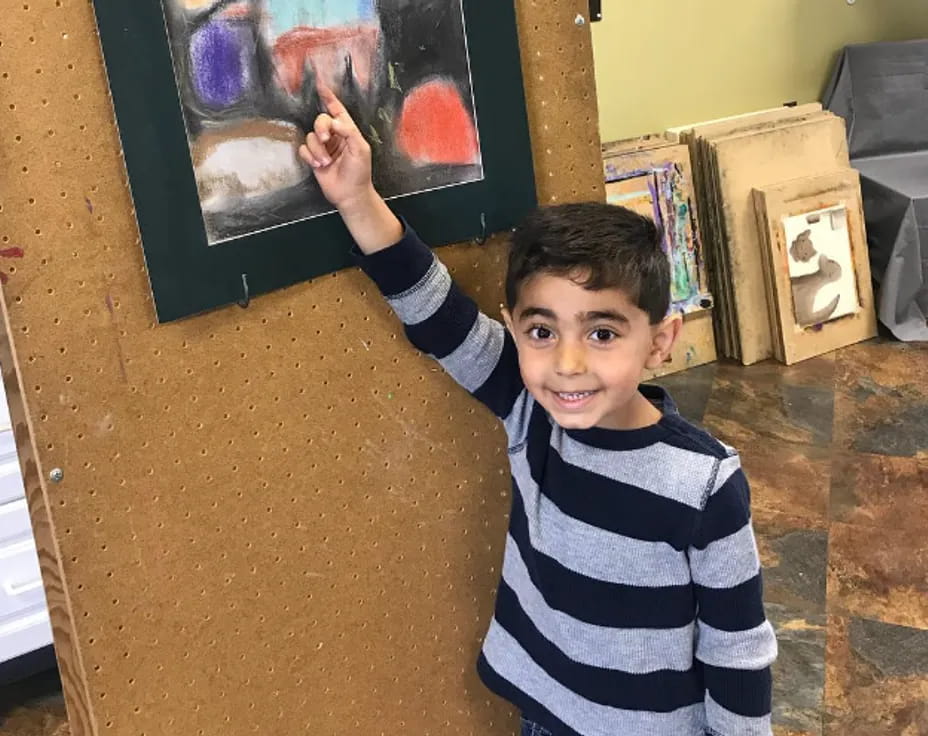 a boy holding his hand up
