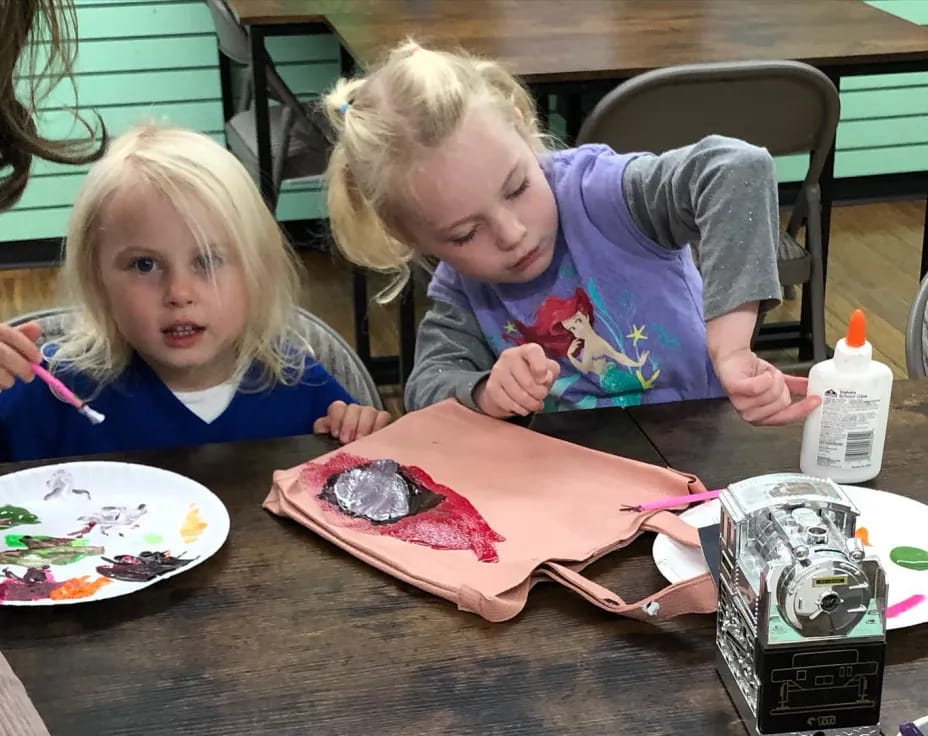 a couple of children eating cake