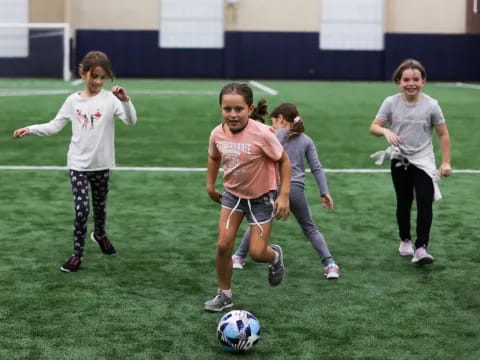 girls playing football on a field