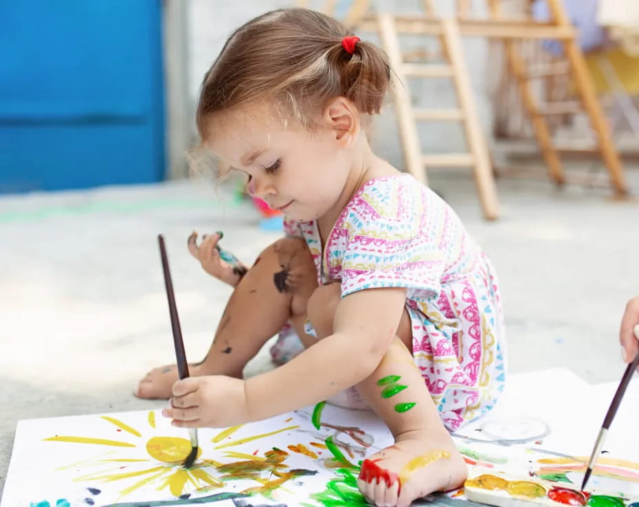 a girl painting with a brush
