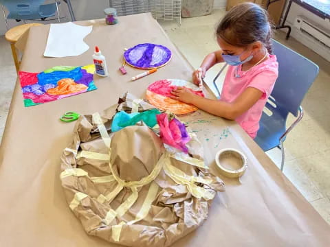 a girl painting on a table