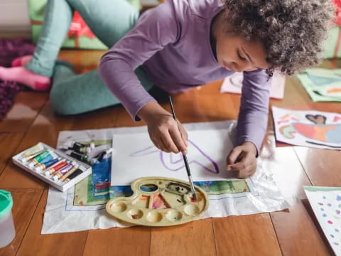 a child painting on a table