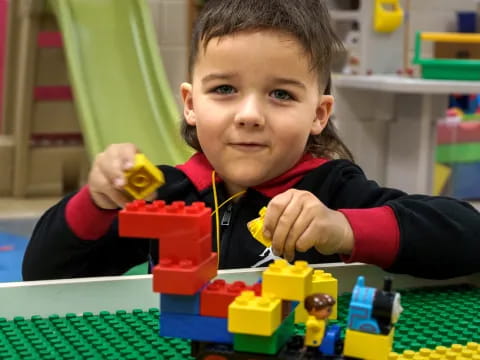 a child playing with a toy train
