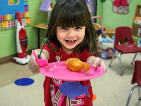 a girl holding a plate of food