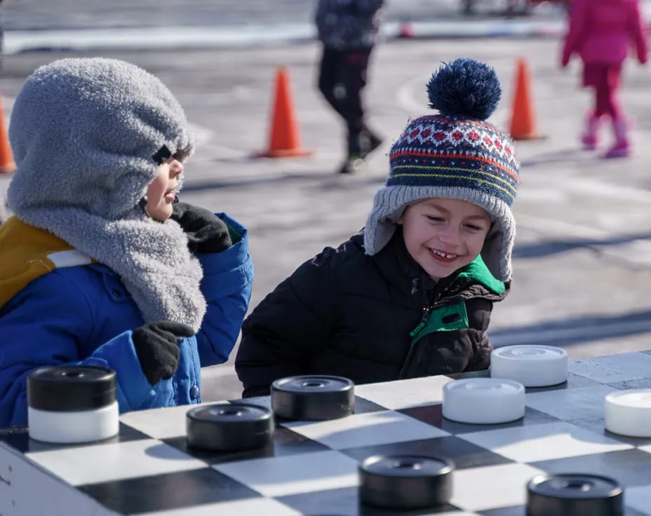 a group of children playing chess