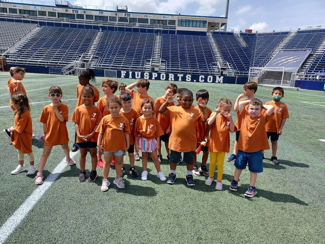 a group of children in orange shirts