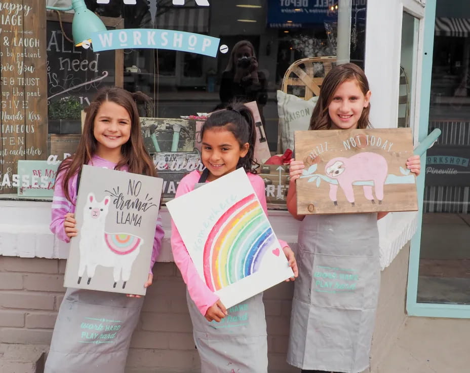 a group of girls holding signs