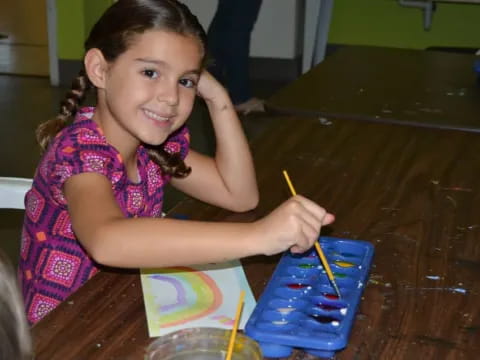 a girl painting on a table