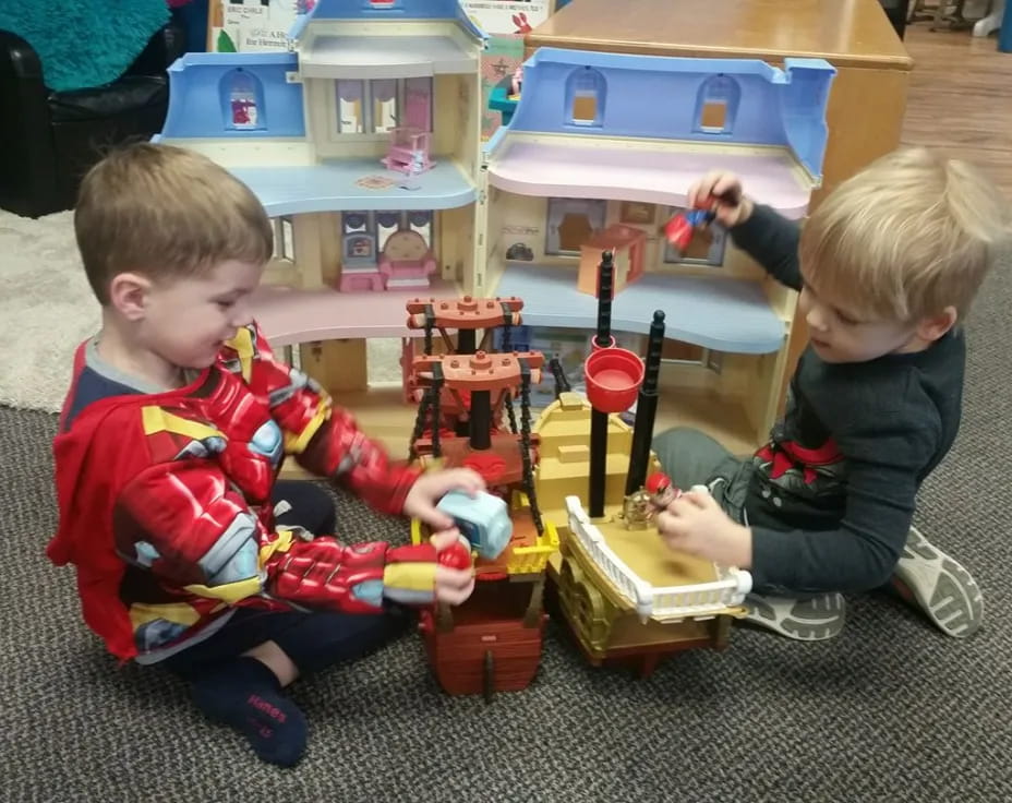 two boys playing with toys