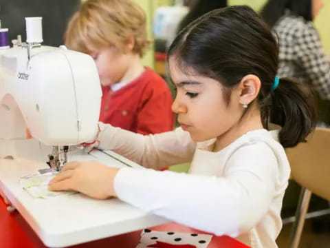 a young girl using a microscope