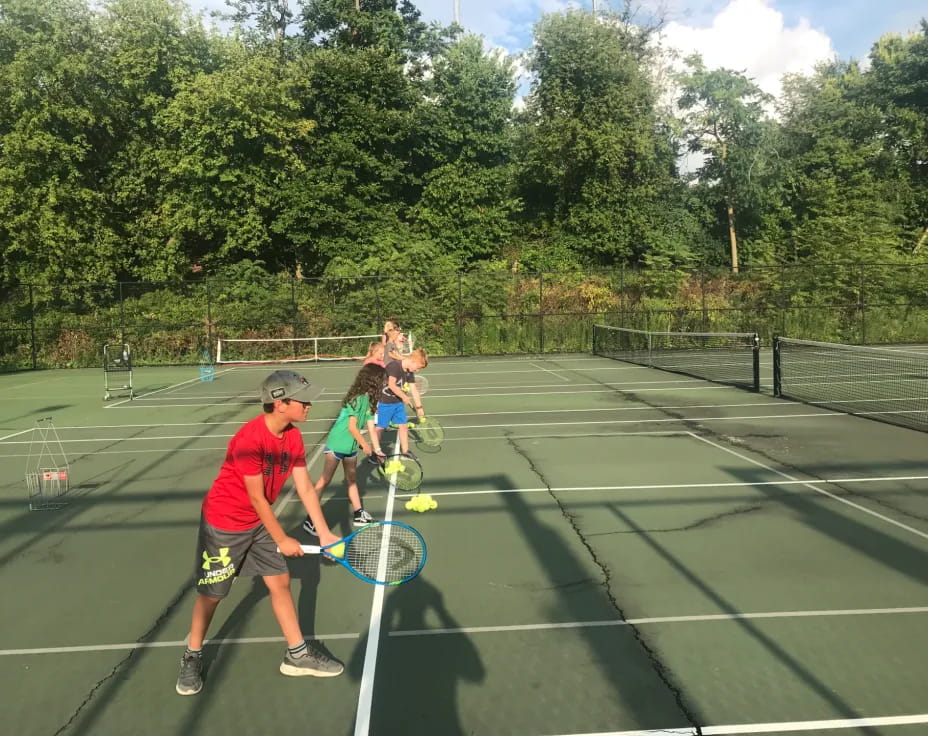 kids playing tennis on a court