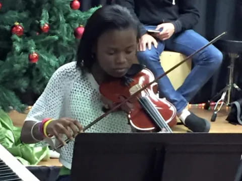 a girl playing a violin