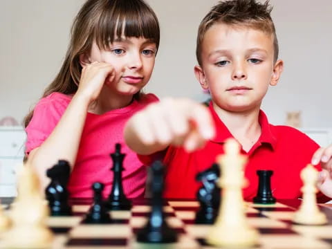 a couple of kids playing chess