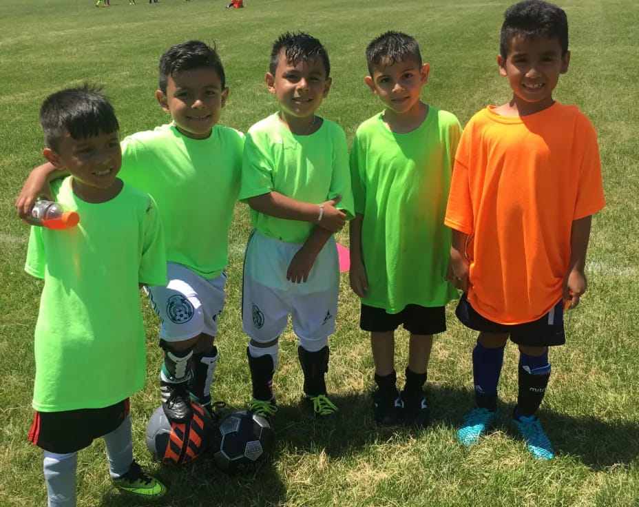 a group of boys in green shirts