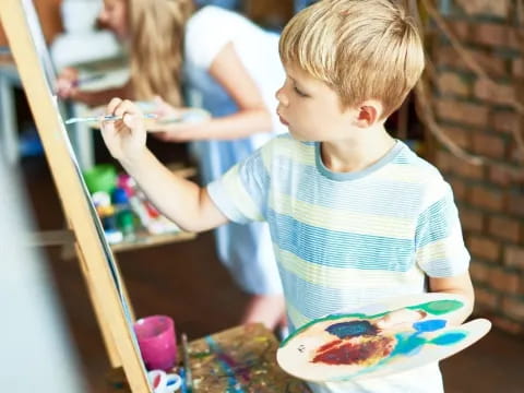 a child looking at a painting