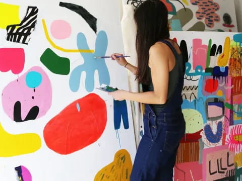 a woman painting a wall