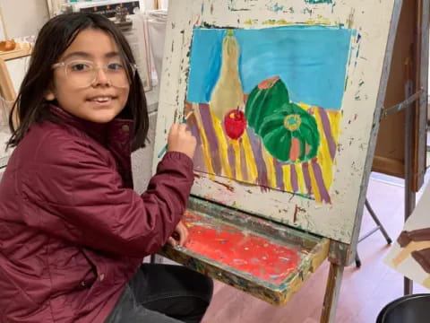 a girl holding a painting