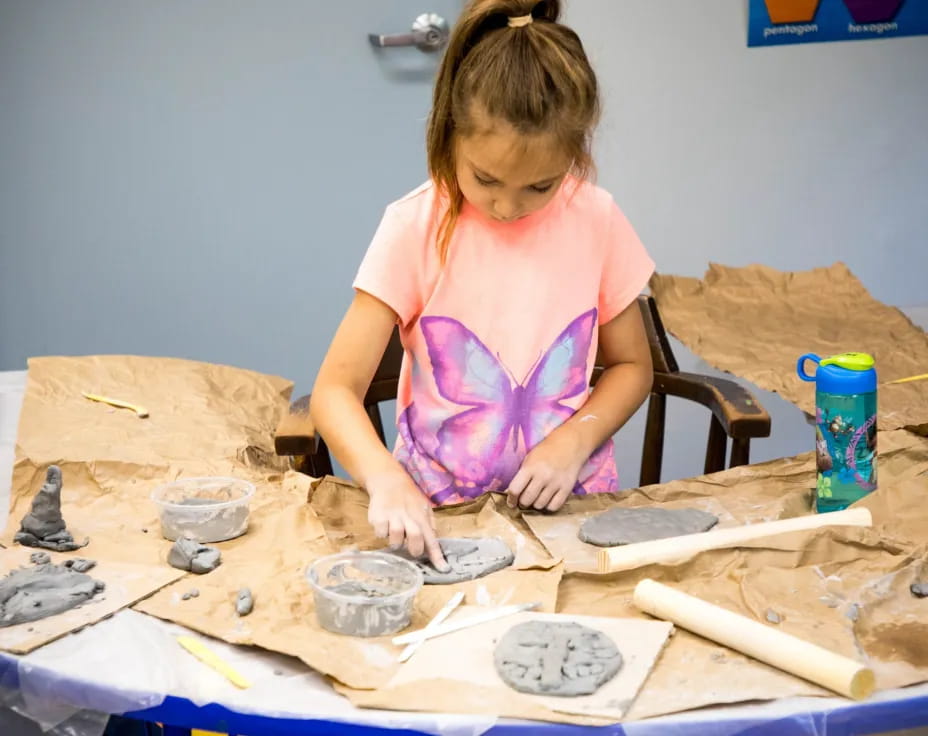 a girl painting on a table