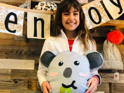 a person holding a stuffed animal