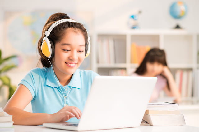 a young girl using a laptop