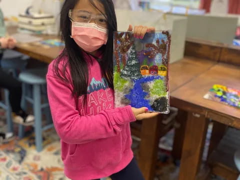 a girl holding a painting