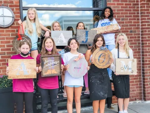 a group of girls holding signs