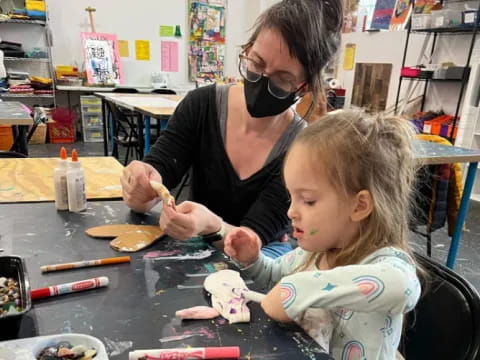 a person and a child painting