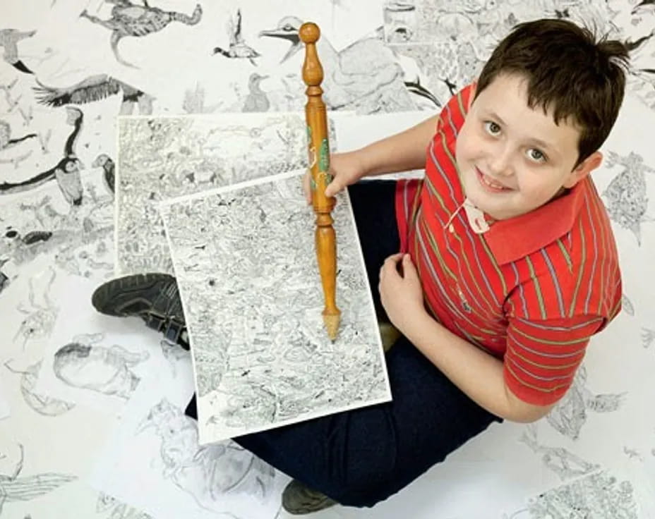 a boy holding a pencil