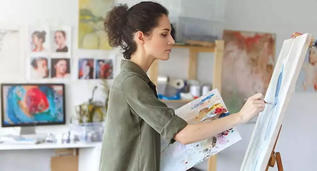a person painting on a easel