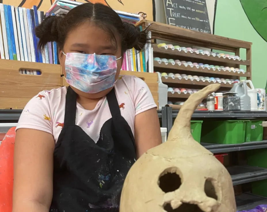 a girl with a mask on her face