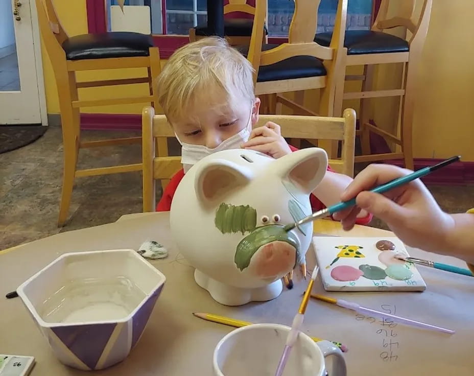 a child painting on a table