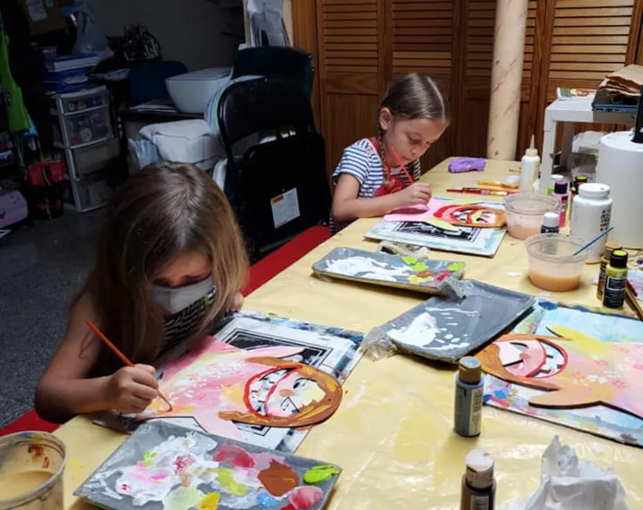 a couple of young girls painting
