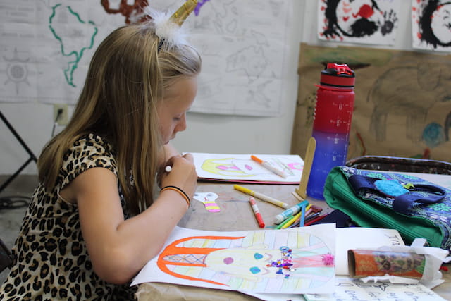 a woman painting on a table