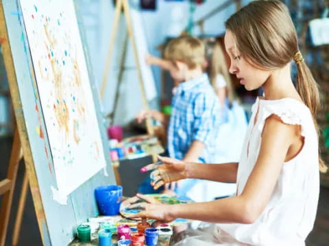 a woman painting a picture