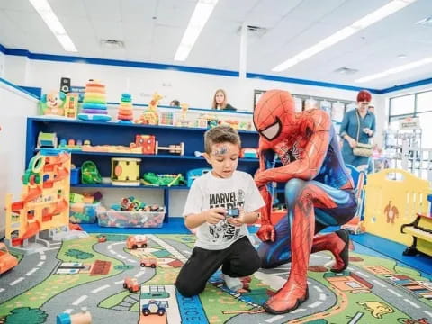 a boy and a person in a playroom