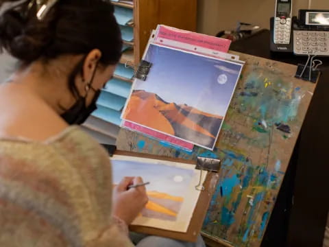 a person painting on a table