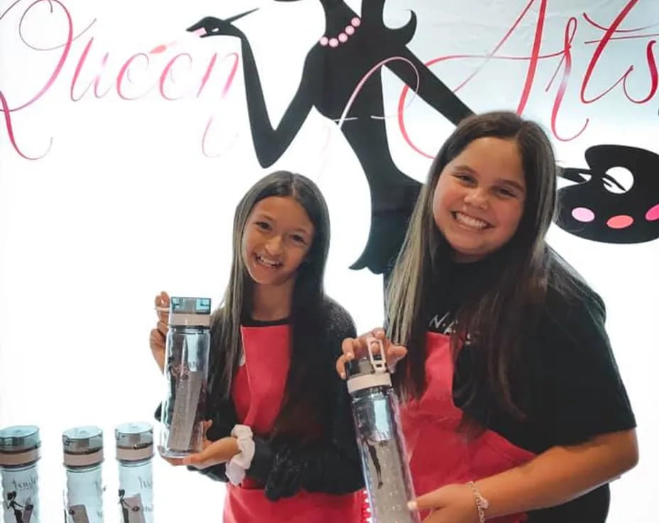 two women holding bottles