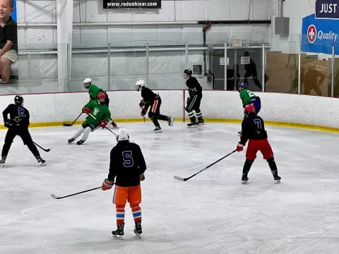a group of people playing hockey