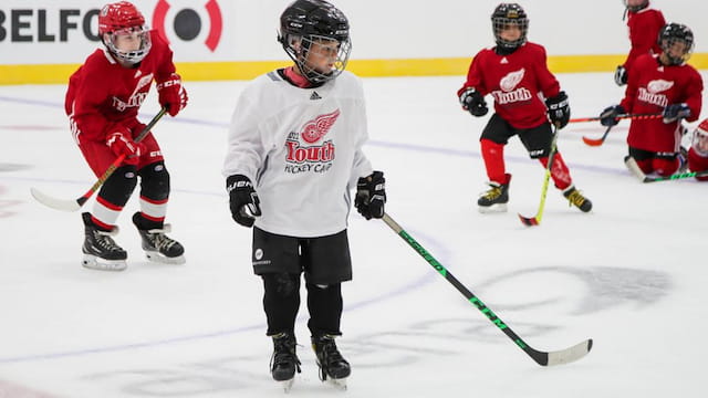 a group of people playing hockey