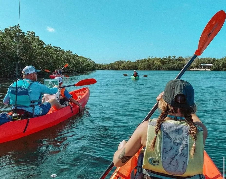 people in kayaks on a river