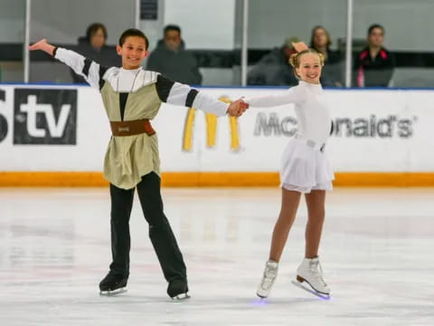 a man and woman ice skating
