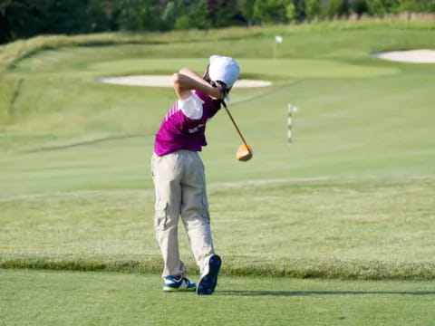 a man swinging a golf club