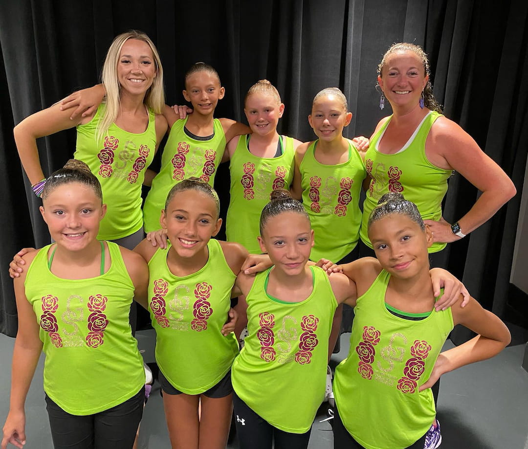 a group of girls in green shirts