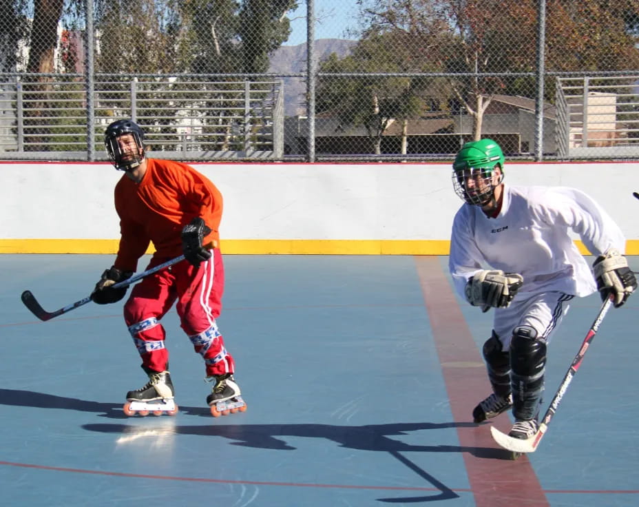 two people playing hockey