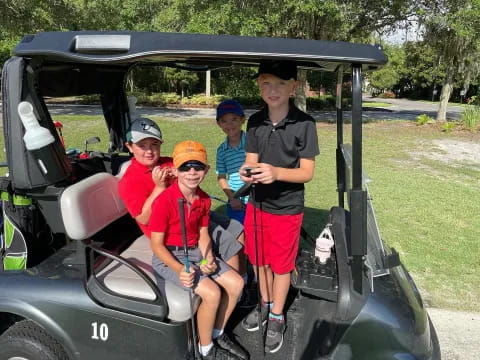 a group of people in a golf cart