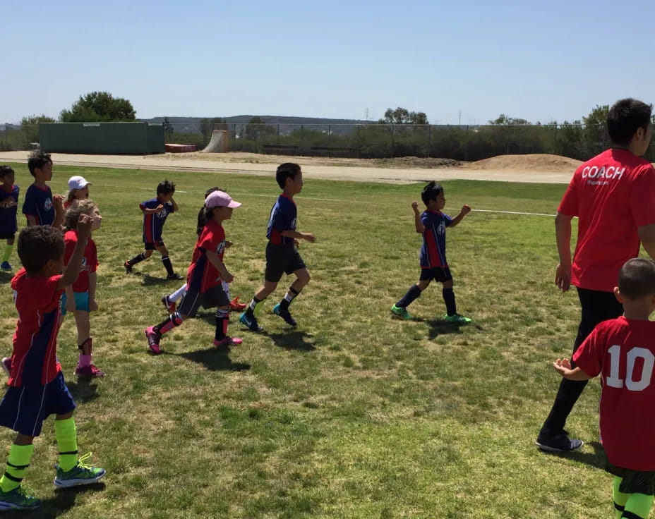 a group of kids playing football