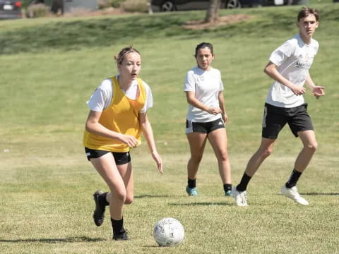girls playing football on a field