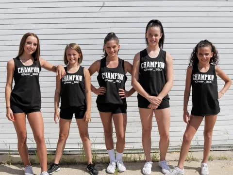 a group of girls in black shirts