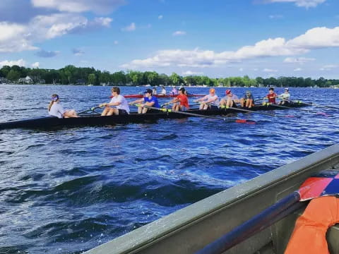 a group of people rowing a boat